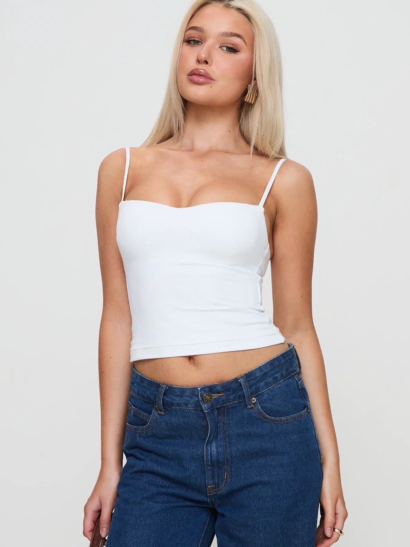 side view of model wearing Princess Polly Evanda Top White Sleeveless Sweetheart 