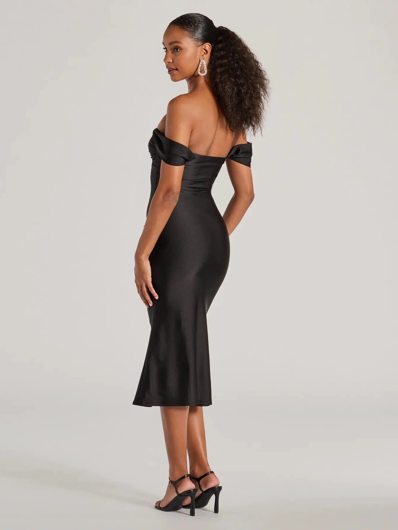 Own the evening in the Exceptional Off-The-Shoulder Flared Midi Dress in black, a cocktail dress perfect for rooftop parties and stylish soirées.