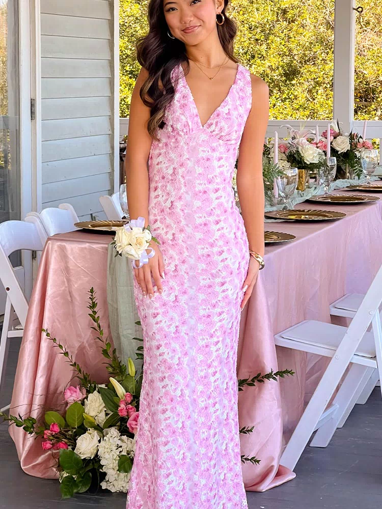 Front view of a pink floral lace maxi dress with a deep V-neckline and fitted silhouette