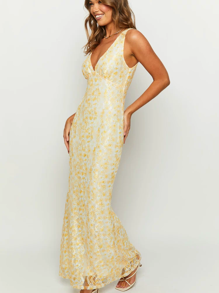 Angled view of a yellow floral lace maxi dress with a V-neckline and fitted silhouette