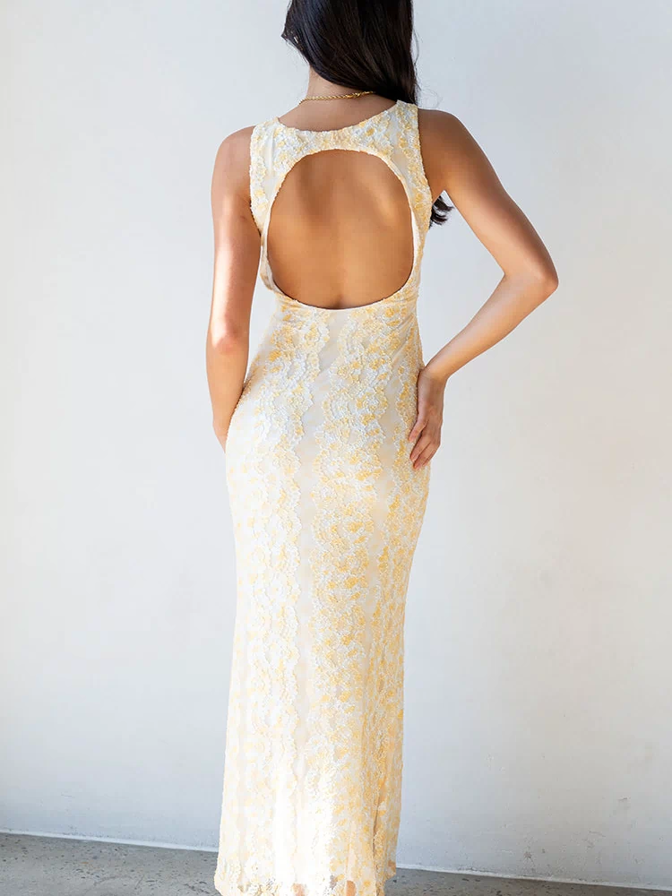 Rear view of a yellow lace maxi dress with a large circular back cutout and low scoop back