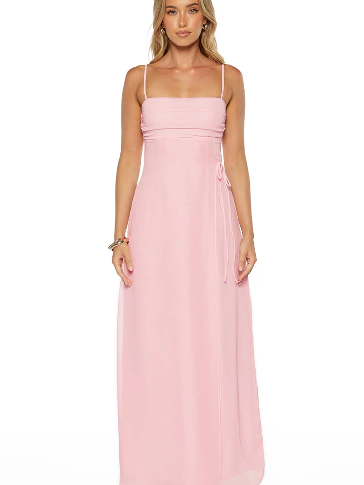 Pink sleeveless maxi dress with a ruched bodice, adjustable side tie, and sheer overlay fabric