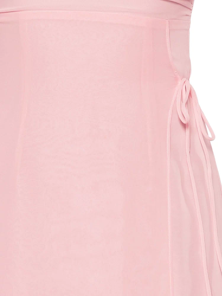 Close-up of the sheer pink fabric and delicate side tie detail on the maxi dress