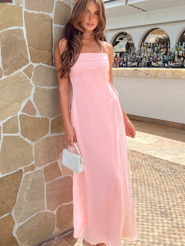 Pink maxi dress with a straight ruched neckline, thin spaghetti straps, and side tie ruching