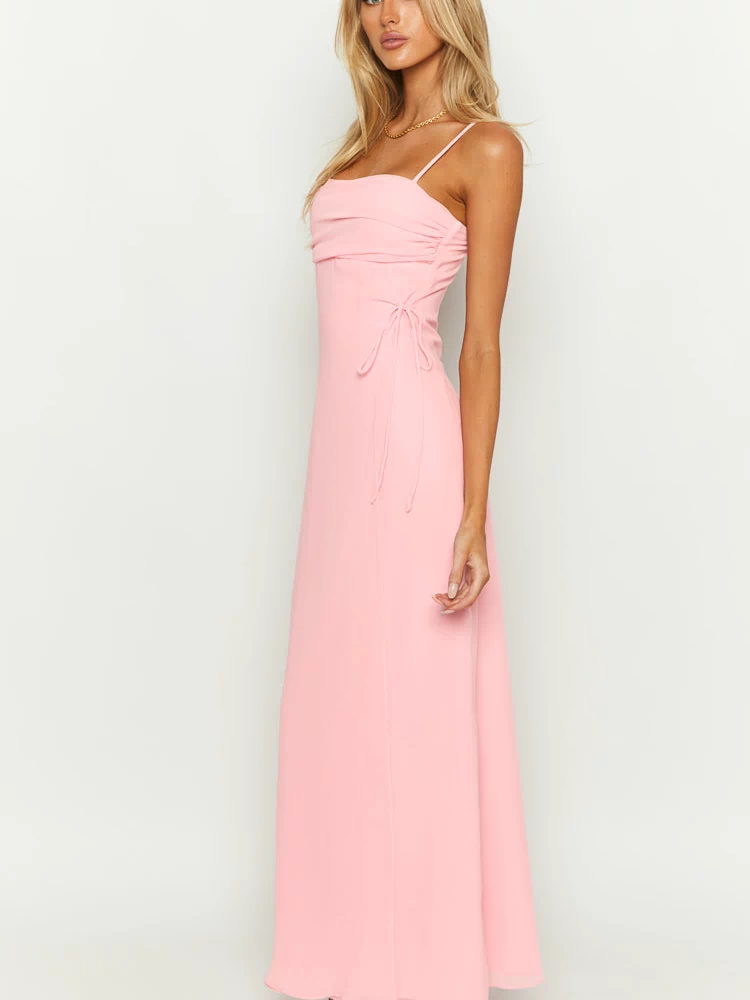 Side view of a pink sleeveless maxi dress with a square neckline, ruched bodice, and side drawstring ties