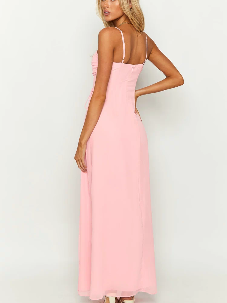 Rear-side view of a pink maxi dress showing thin spaghetti straps, a low back, invisible zipper, and side ruching