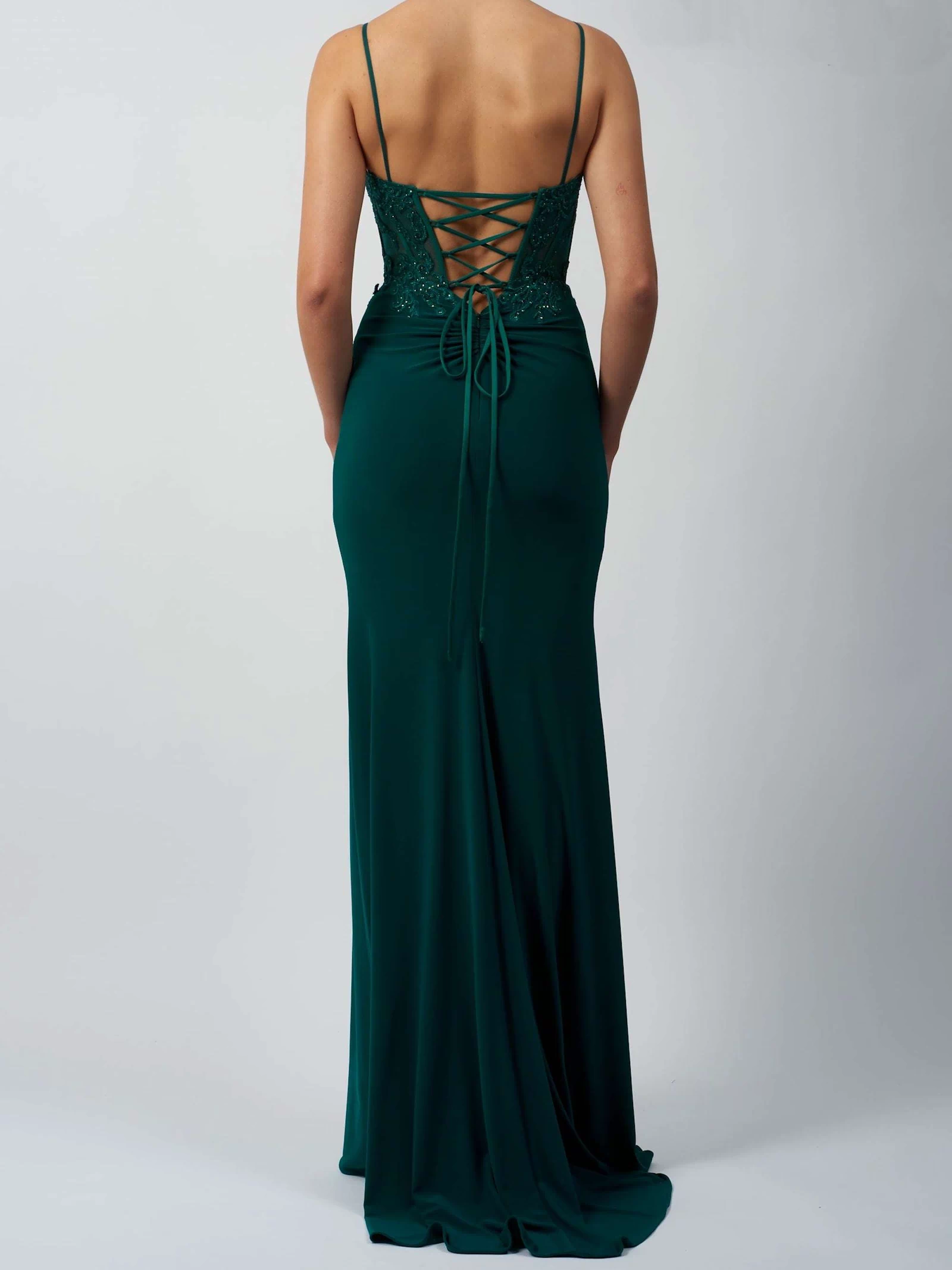 back view of model in green fitted corset dress