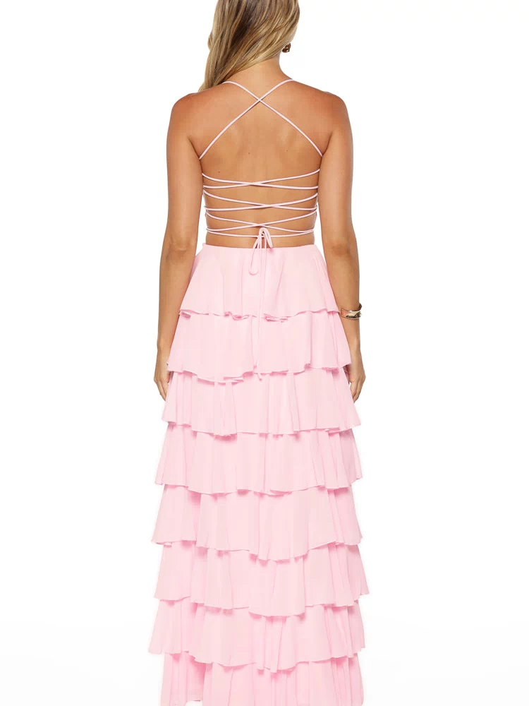 Back view of a pink maxi dress with a criss-cross lace-up back and a tiered ruffle skirt