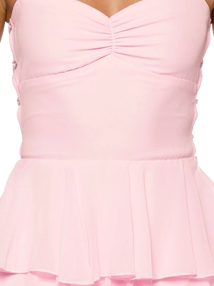 Pink maxi dress close-up highlighting the ruched bust, fitted waist, and delicate tiered ruffles
