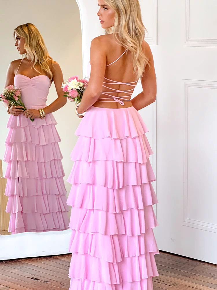 Back view of a pink maxi dress with a criss-cross lace-up back and full tiered ruffles