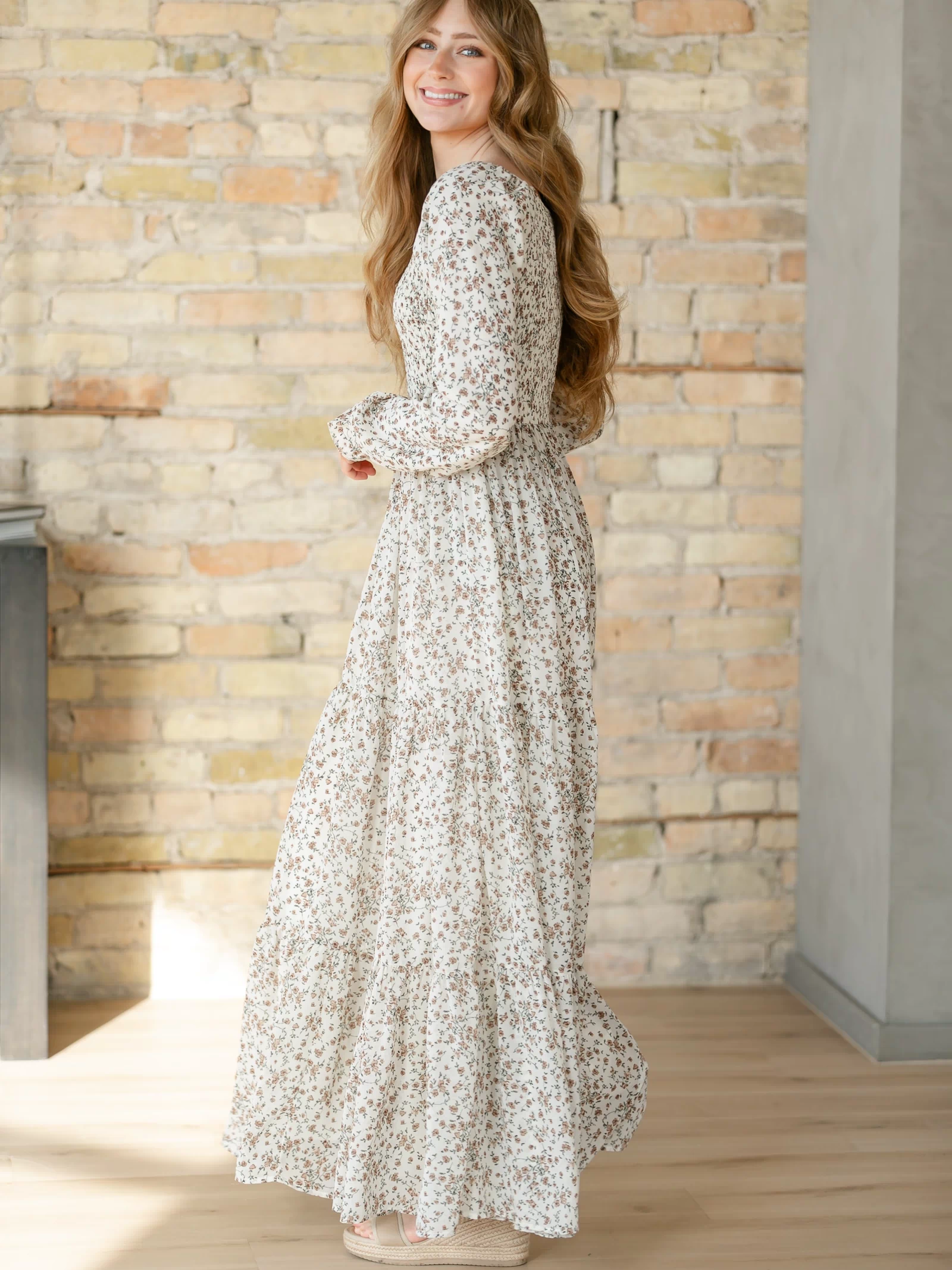 Side view of a floral dress with long sleeves.