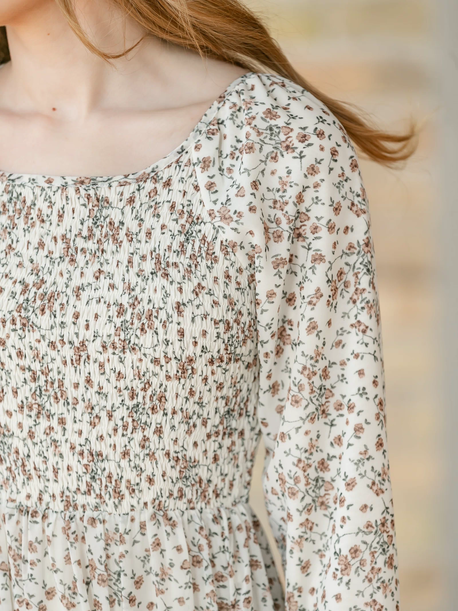 Close-up of the shoulder of a floral dress.