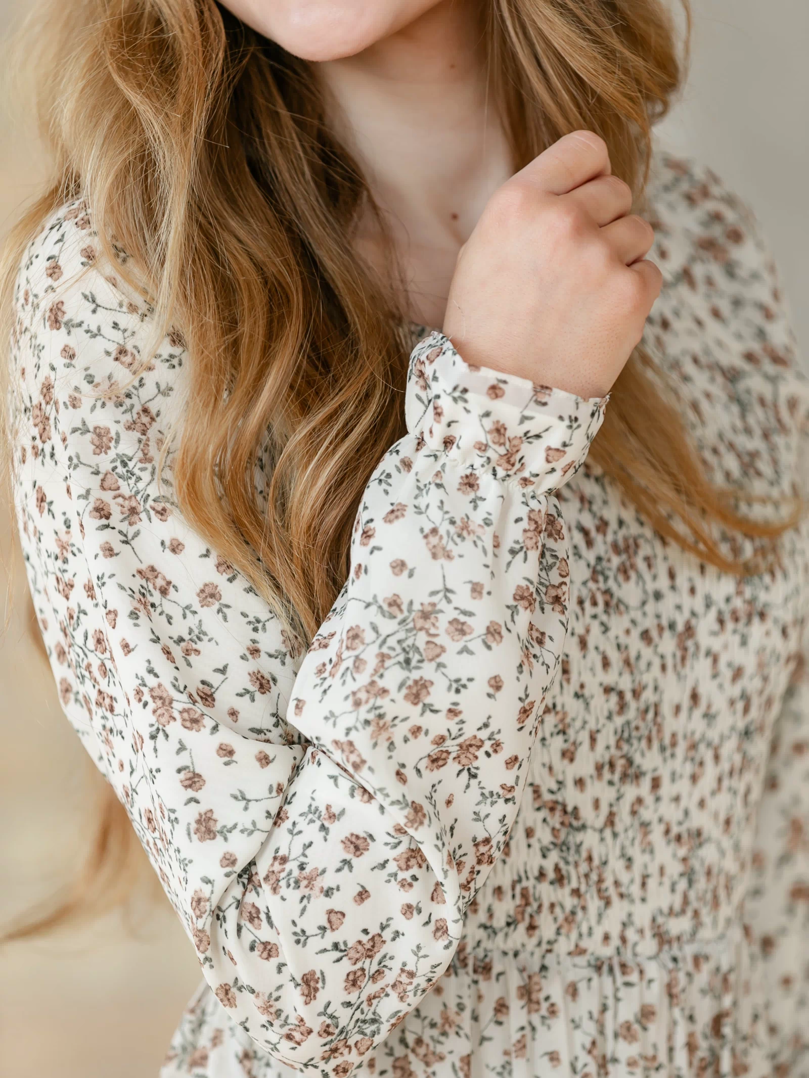 Close-up of the sleeve cuff of a floral dress.