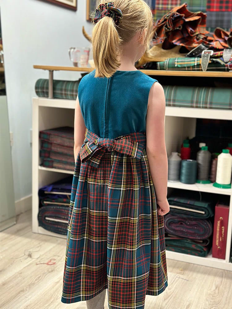 Side view of the Girls Tartan and Velvet Dress emphasizing the high-quality velvet and pure wool tartan, perfect for special occasions.