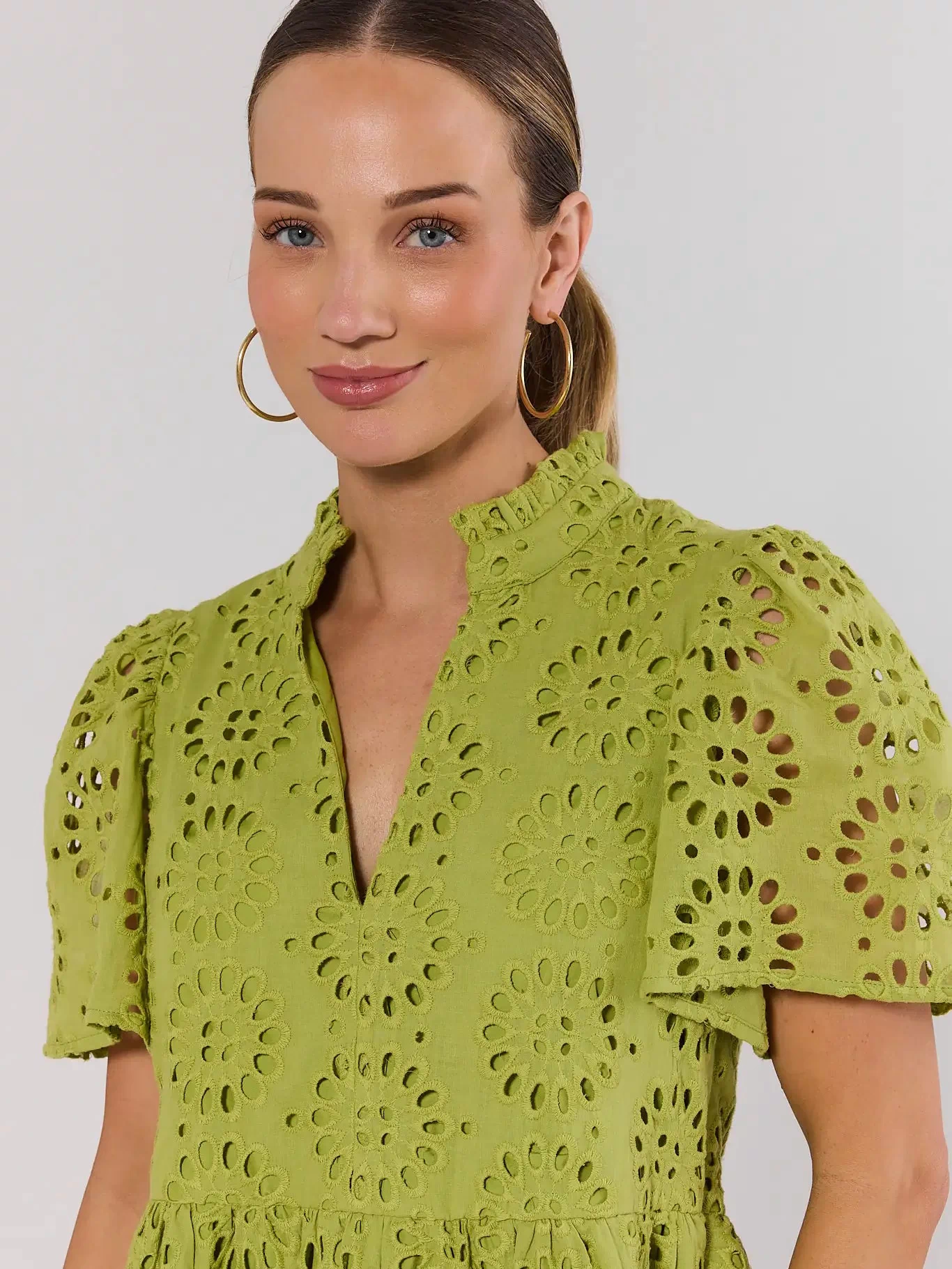 Green Eyelet Dress Close-Up Detail - Ruffle Mock Neck and Puff Sleeve | Avara