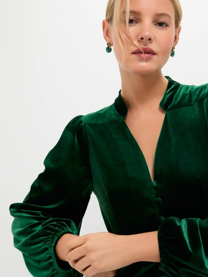 Person modeling the Green Velvet Serena Dress, featuring classic, long balloon sleeves and a fitted waist, exuding an effortless, high-end style perfect for fun, celebratory occasions.