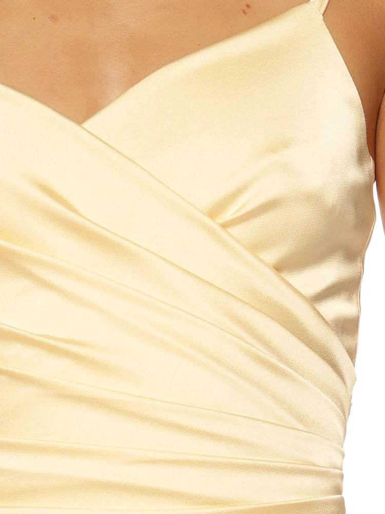 Close-up of the yellow satin mini dress bodice, highlighting the wrap neckline and full ruching