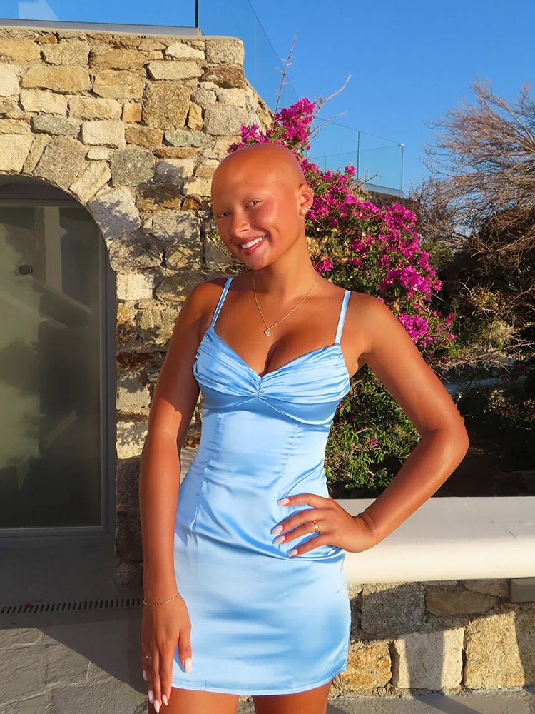 Front view of a light blue satin mini dress with a ruched sweetheart neckline and thin spaghetti straps