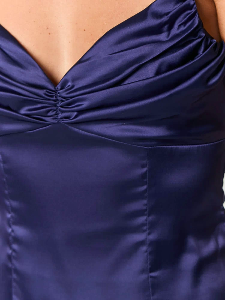 Close-up of the navy satin mini dress bodice with a ruched sweetheart neckline and tailored seaming