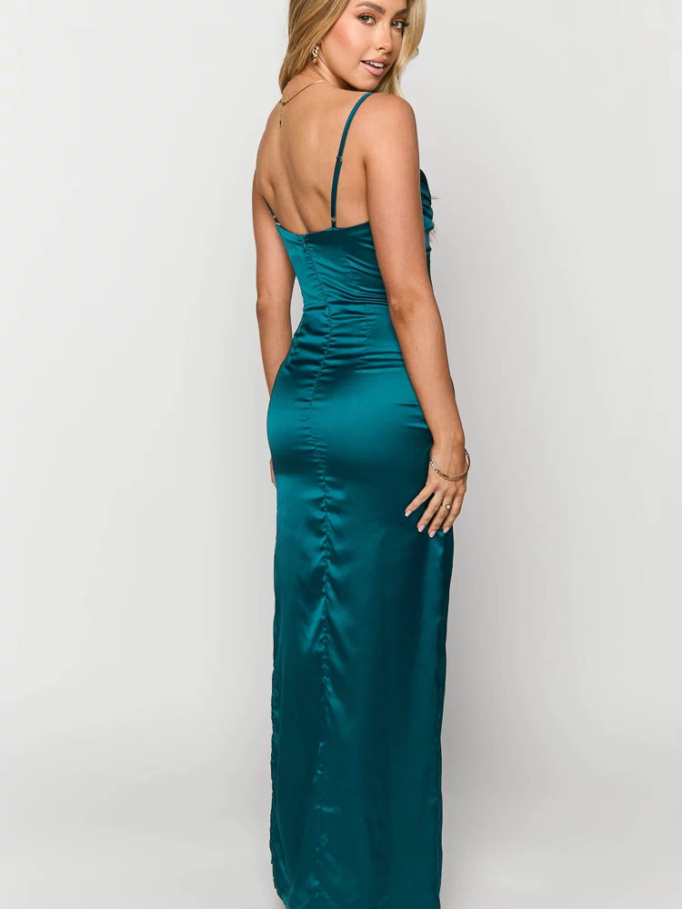 Rear view of a teal satin maxi dress with a fitted silhouette, back zipper, and ruched detail