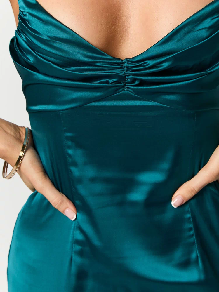 Close-up of the ruched sweetheart neckline and gathered bust detail of a teal satin maxi dress