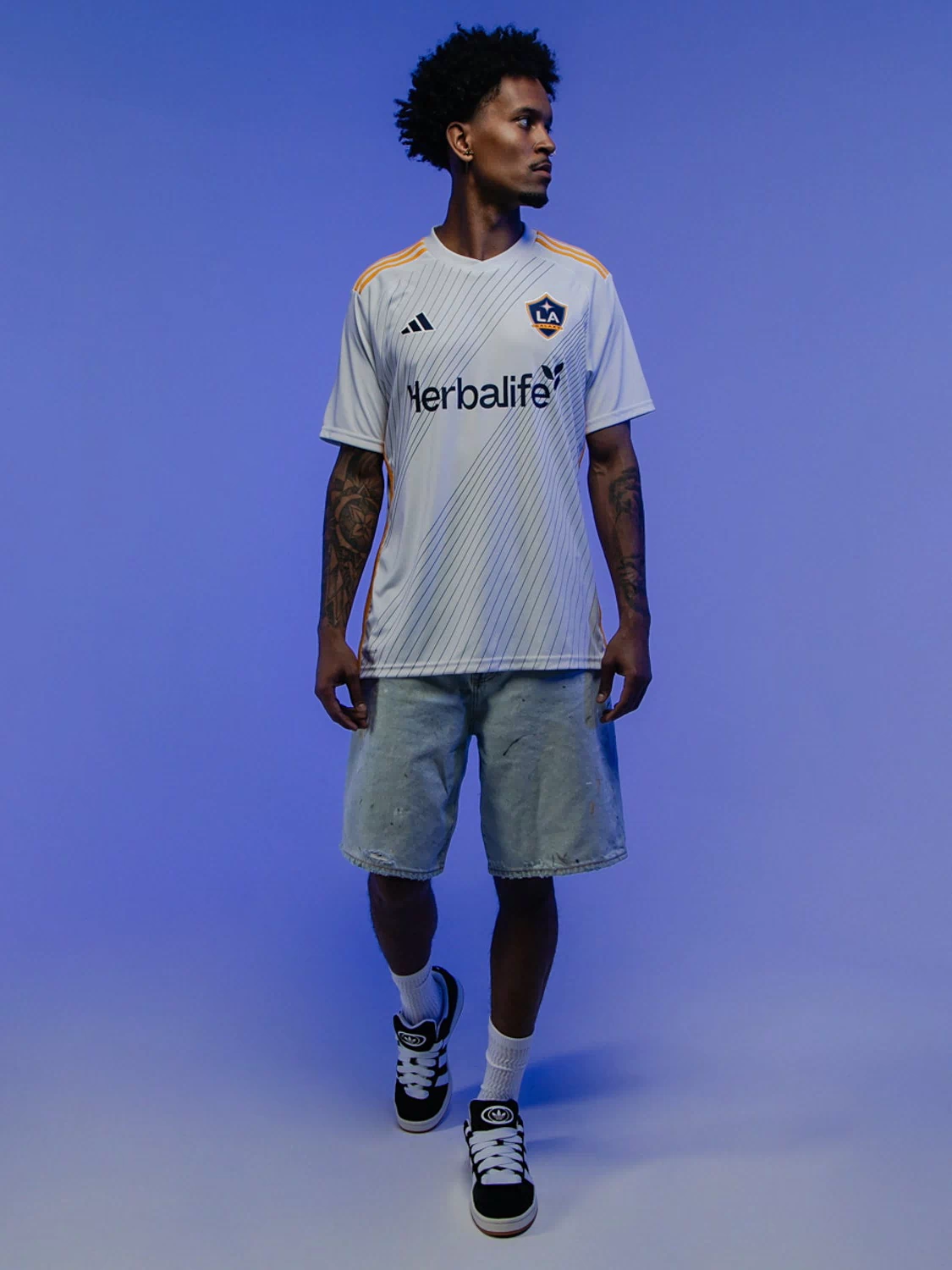 Men's adidas Campus 00s sneakers worn with light shorts and striped jersey