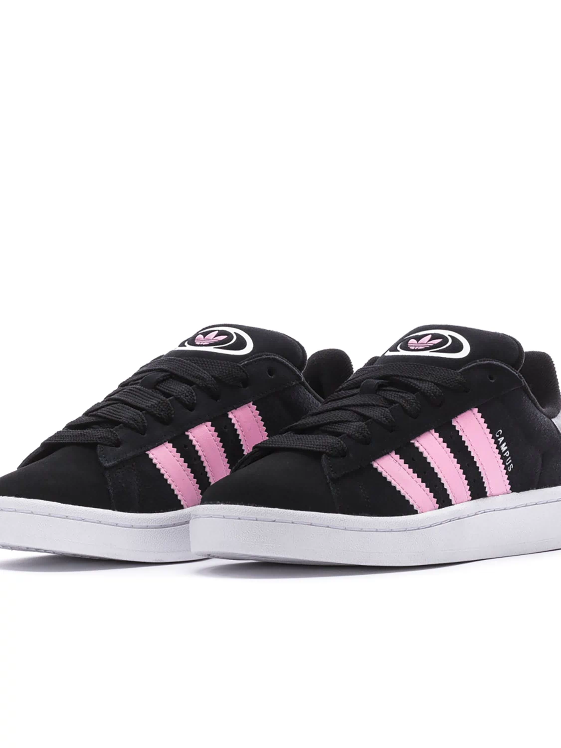 Black low-top sneakers with pink and white triple stripes and lace-up closure.