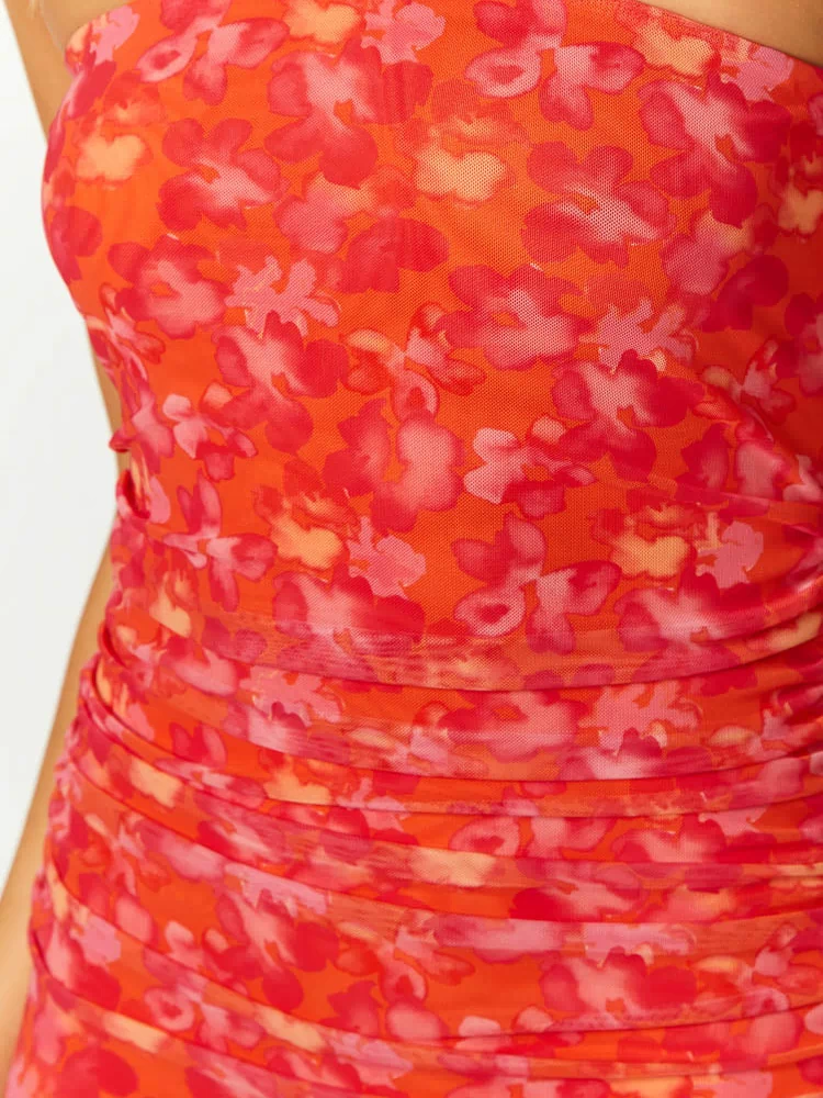 Close-up of the orange floral print mesh maxi dress showing ruched detailing on the bodice and waist