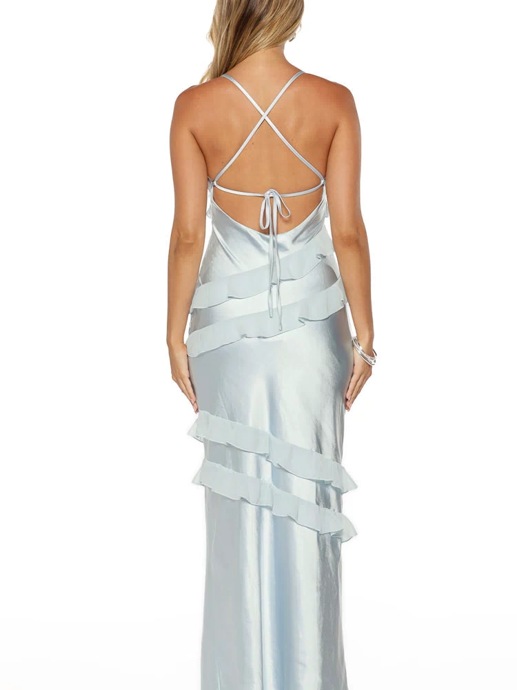 Rear view of a light blue satin maxi dress with criss-cross spaghetti straps, a tie-back, and tiered ruffles