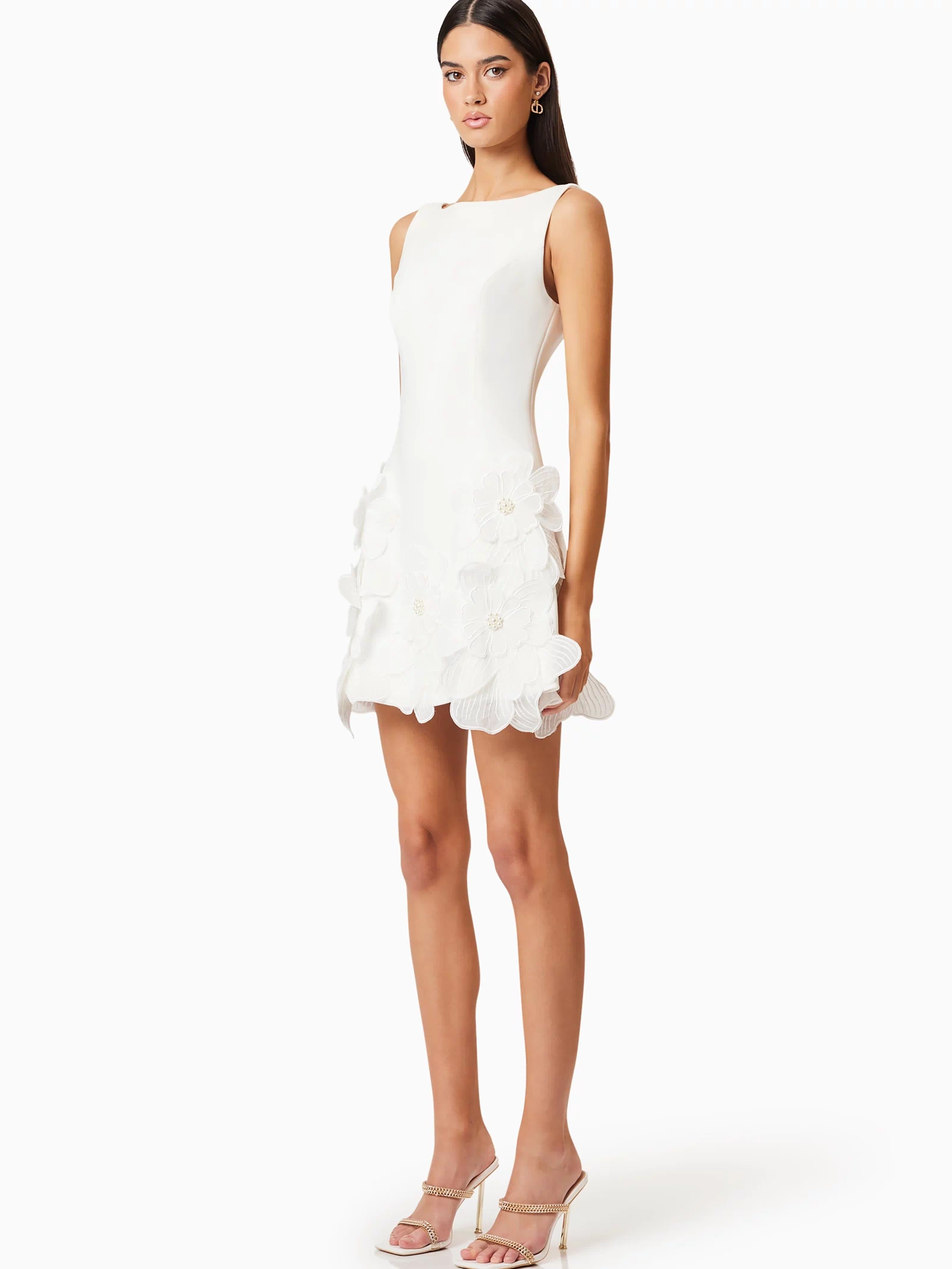 Brunette model wearing Janelle Mini Dress In White side shot