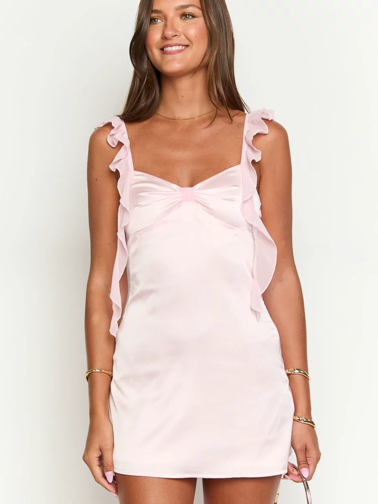 Pink satin mini dress with a sweetheart neckline, bow detail at the bust, and ruffled sheer organza straps