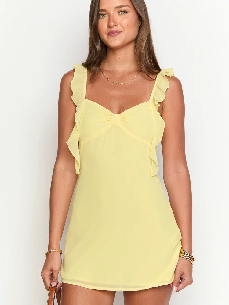 Yellow chiffon mini dress with ruffled shoulder straps and a gathered detail at the sweetheart neckline