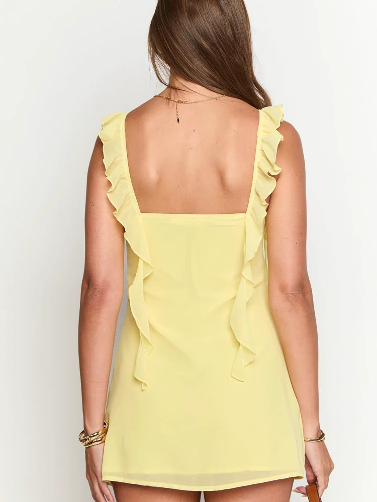 Rear view of a yellow chiffon mini dress with a square back and ruffled straps extending down the back
