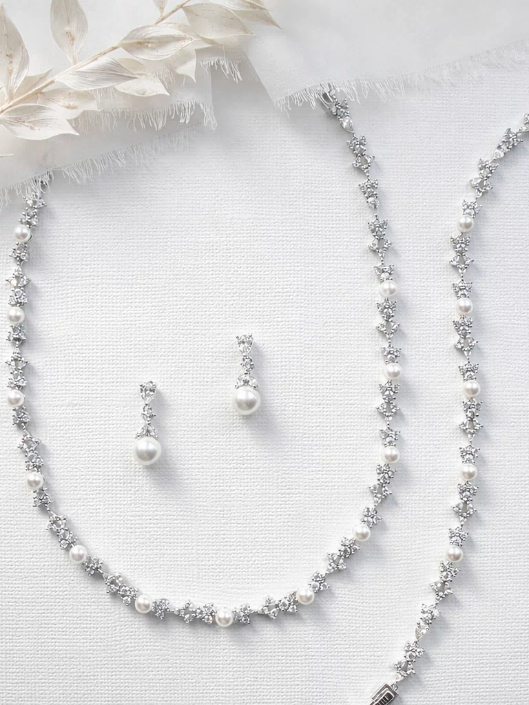 a collection of elegant jewelry pieces, including a necklace, earrings, and a bracelet, all adorned with sparkling diamonds and pearls.
