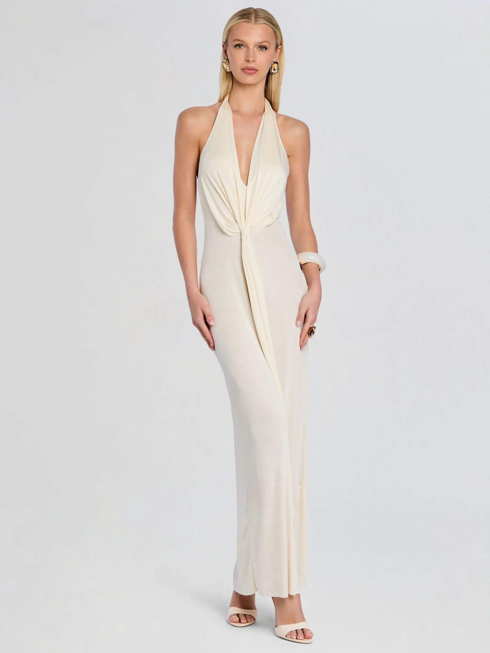 Front view of ivory Kayla Maxi Dress with halter neck and draped knot at the waist