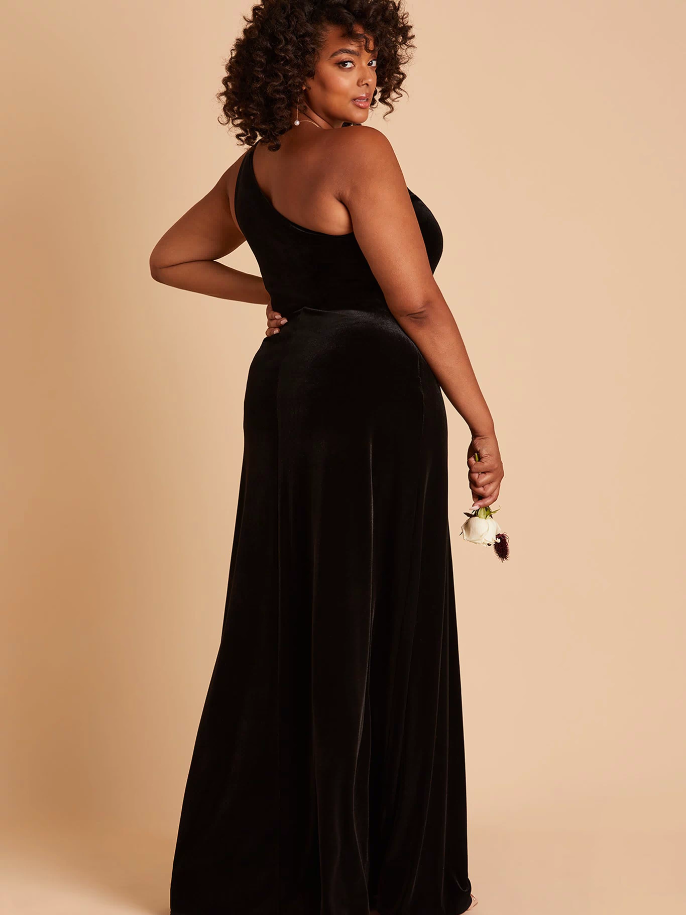 Kira plus size bridesmaid dress with slit in black velvet by Birdy Grey, side view