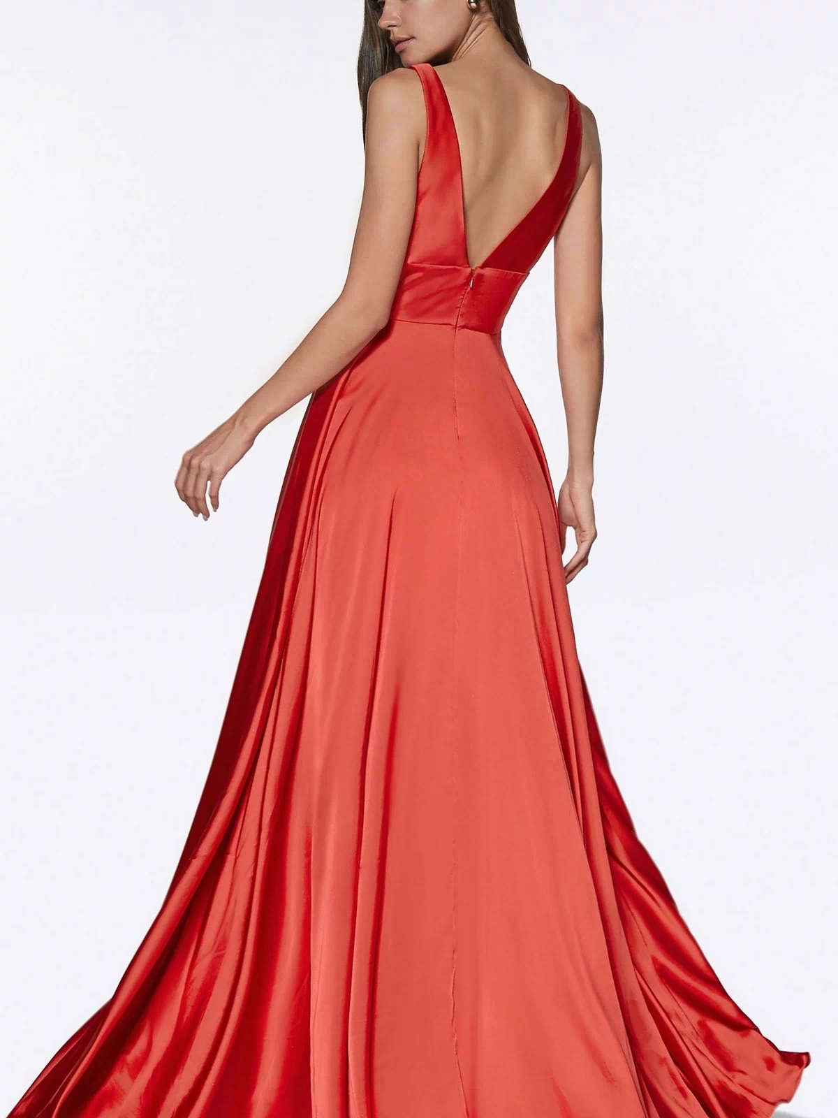 A woman in an Empire-Waist Simple Satin Long A-Line Prom Dress stands against a plain white background, backless and sleeveless, facing away while looking over her shoulder.
