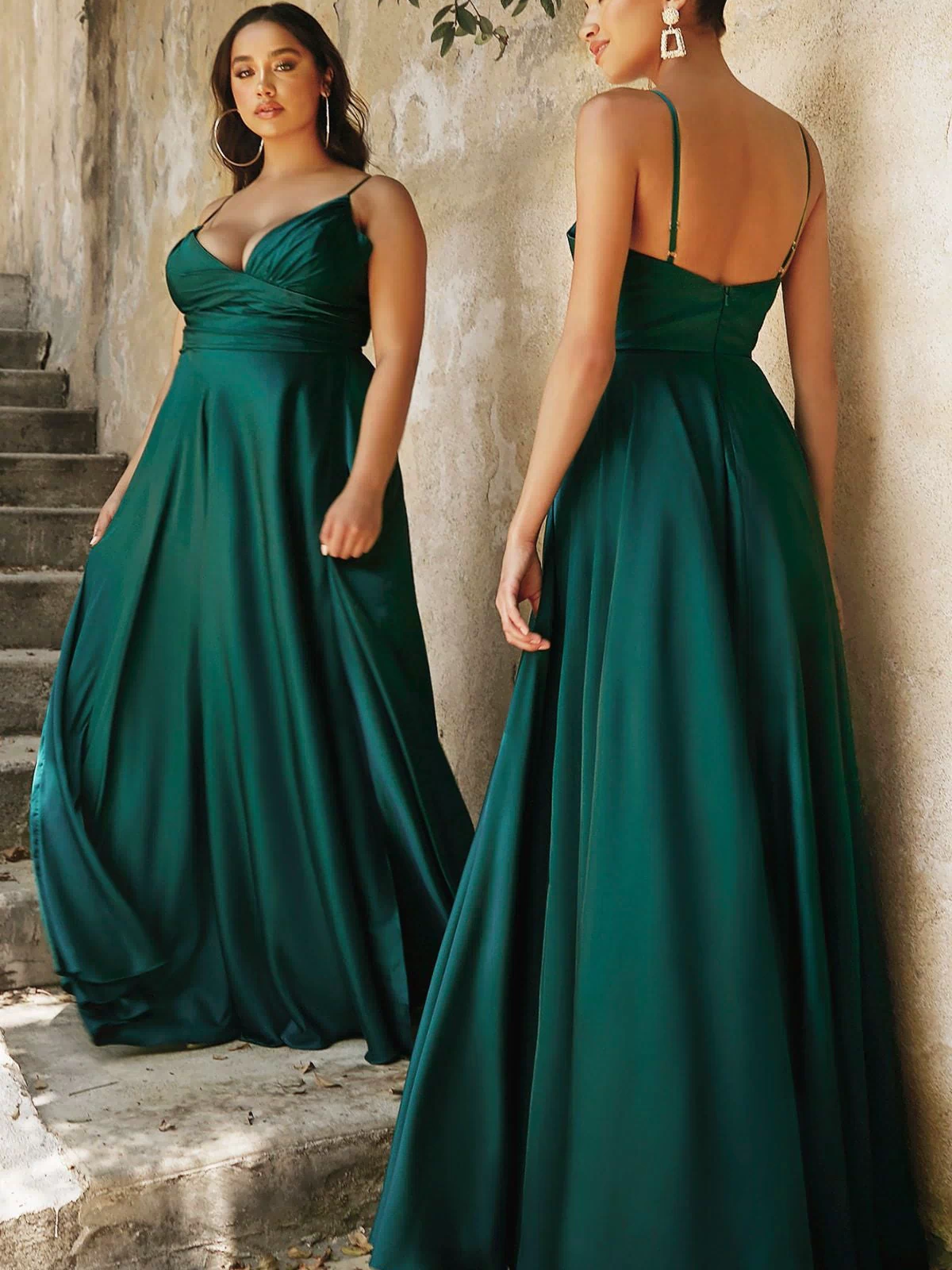 Two women, one facing forward and the other with her back turned, stand outdoors near stone steps and a textured wall, both elegantly showcasing the Ladivine 7485 Classic Long Satin Formal Prom Dress.