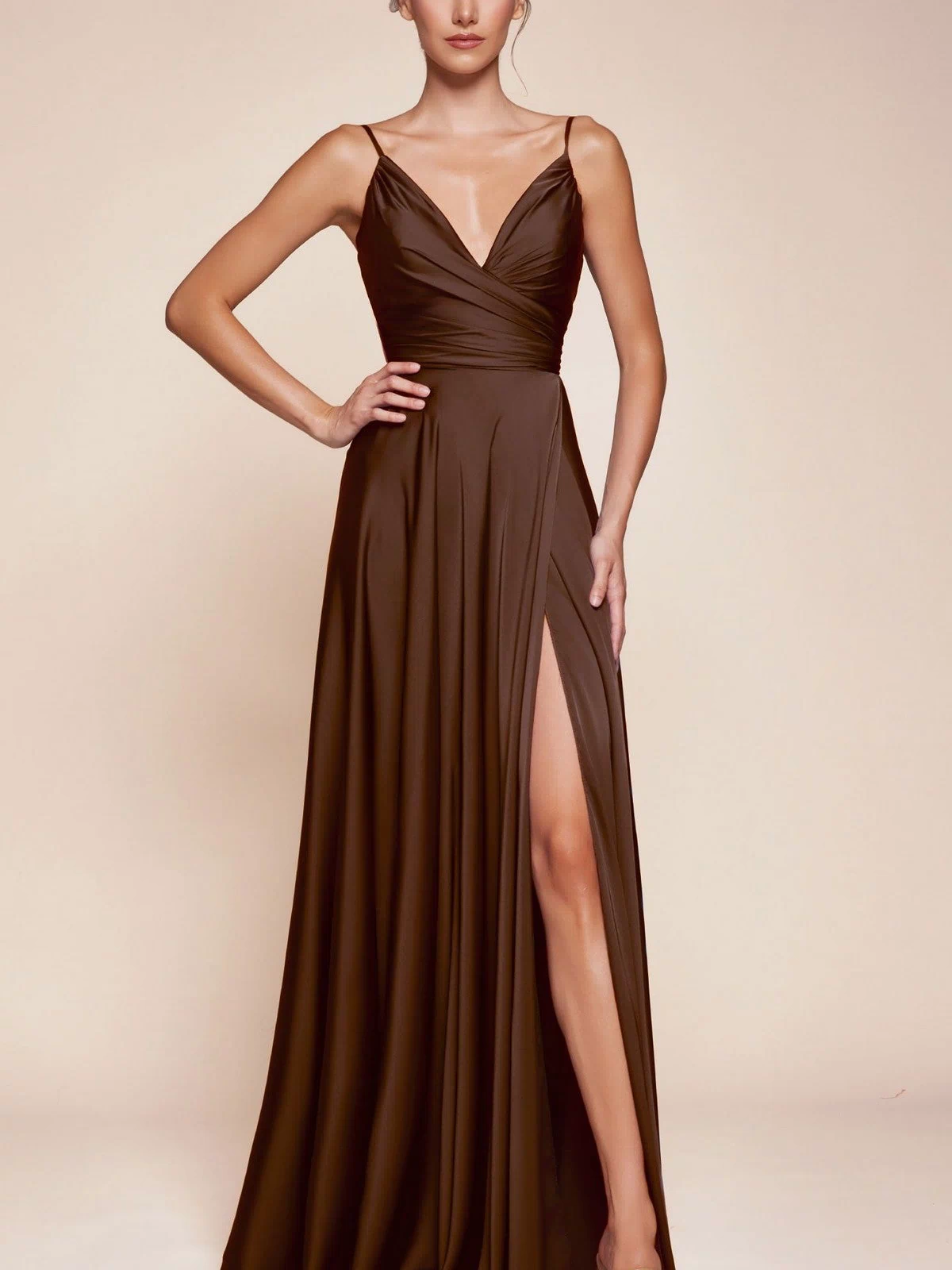 A woman poses with one hand on her hip in the Ladivine 7485 Classic Long Satin Formal Prom Dress, a sleeveless floor-length gown with a thigh-high slit, set against a neutral background.
