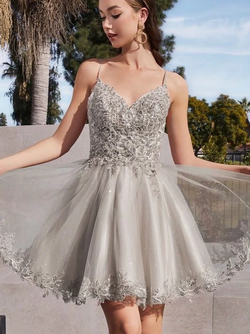 A woman stands outdoors holding the sides of her Short Homecoming Dress CD0213, featuring sleeveless silver lace, embroidery, a flared tulle skirt, and an a-line silhouette.