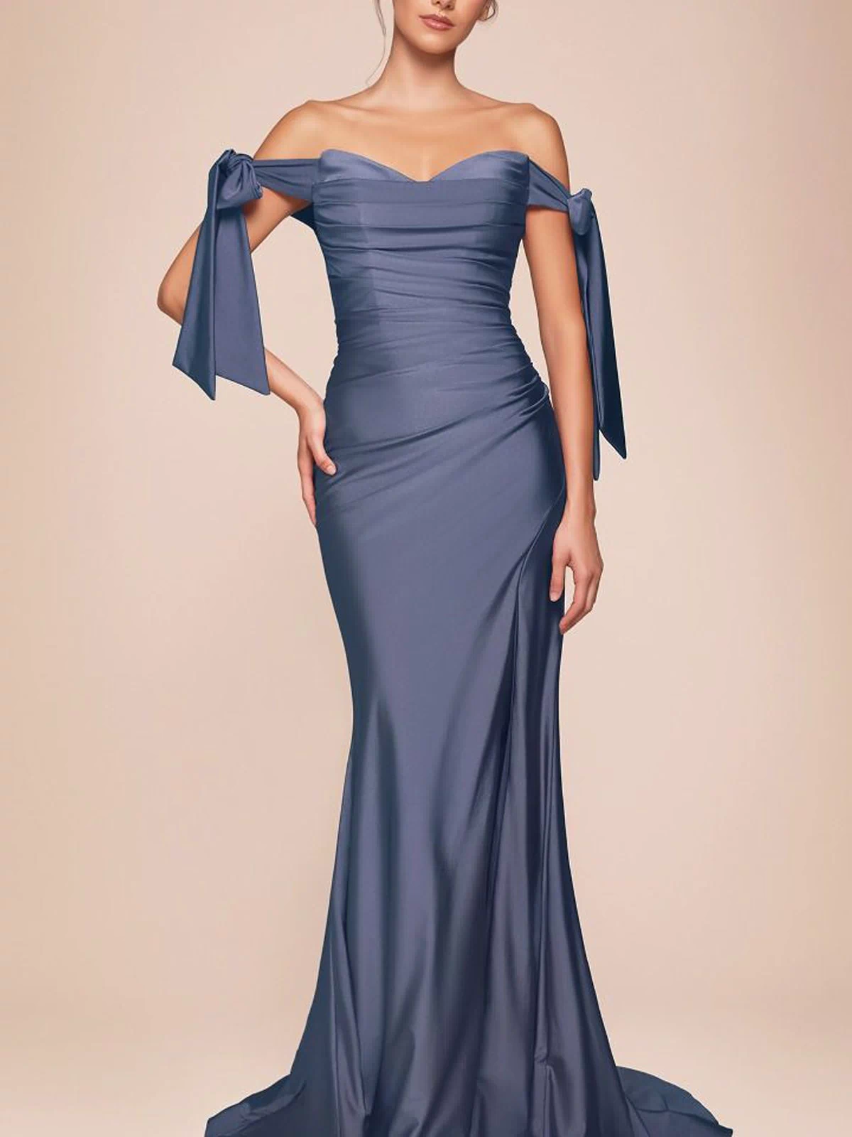 A woman wears the Ladivine CD943 Off-Shoulder Ruched Prom Dress in smoky blue, featuring ribbon-tied sleeves and a floor-length silhouette, standing against a neutral background.