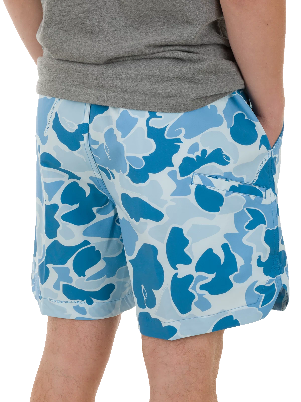 Close-up of a person wearing Lake Shore Dock Short, featuring a light-blue camo pattern, elastic waistband, and mesh-lined pockets, capturing the essence of water-ready comfort.