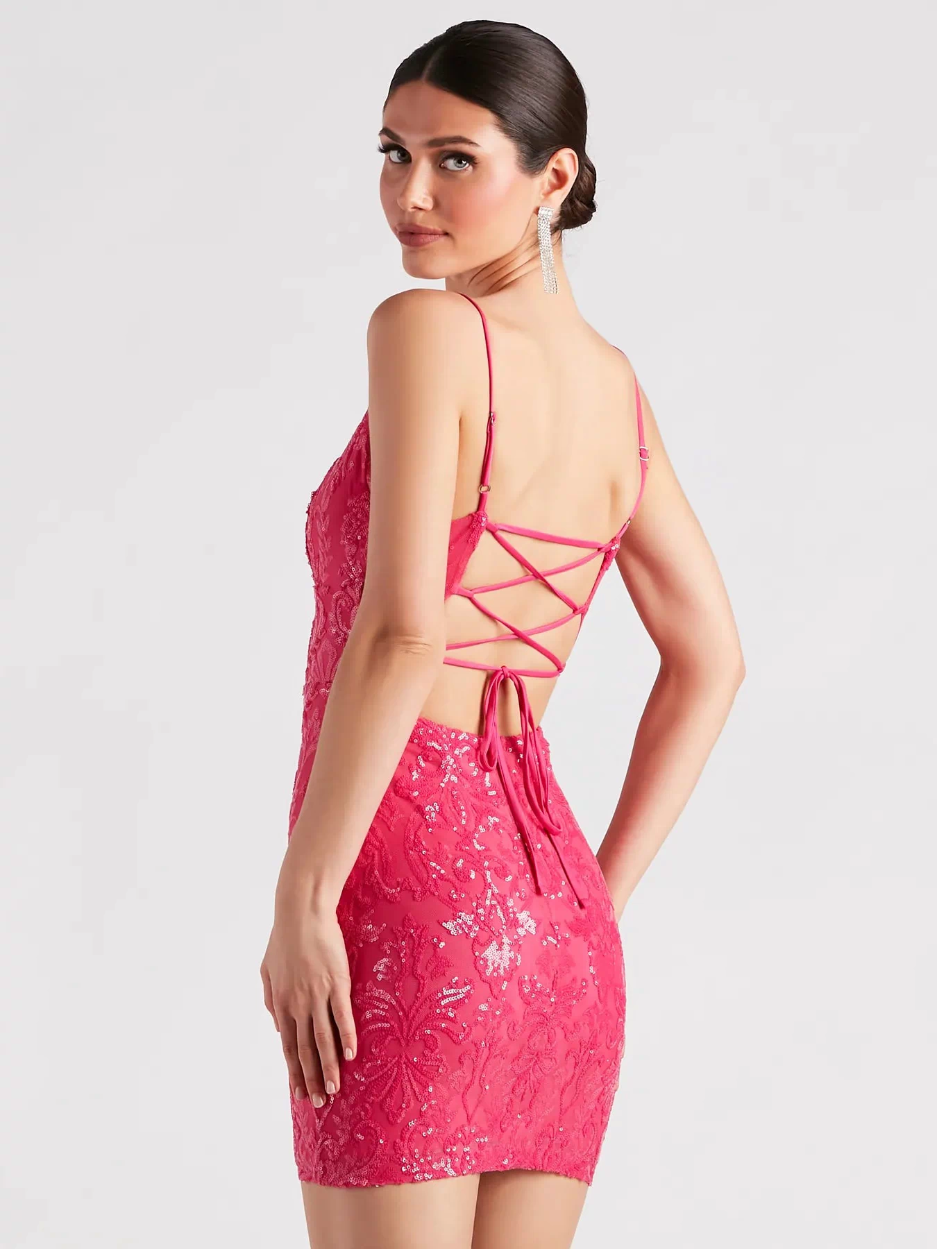 This fuchsia prom dress, the Leila Sequin Bodycon Mini Dress , features a sleek, floor-length design with trend-forward details that capture the excitement of Prom 2026.