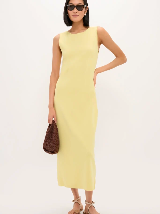 Lemongrass Kingston Knit Dress: A classic, effortless column-style midi dress paired with beige strappy sandals and a woven handbag, embodying fun and high-end fashion.