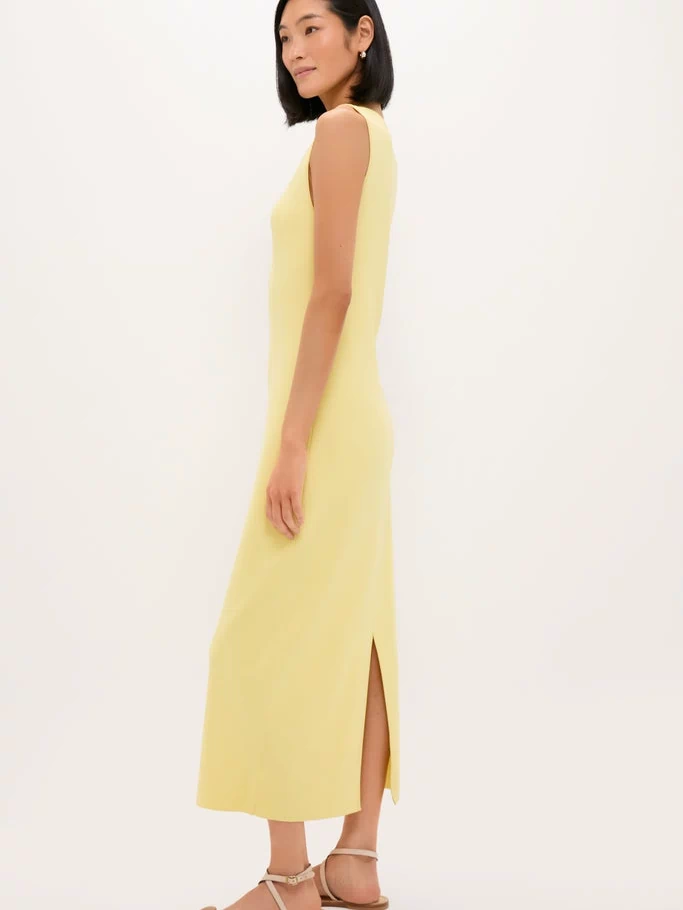 Lemongrass Kingston Knit Dress: Classic, effortless column-style midi with a chic slit, modeled by a slim woman in strappy sandals, embodying high-end, fun sophistication.