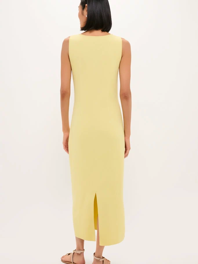 Person wearing the classic Lemongrass Kingston Knit Dress, an effortless chic midi with a back slit, styled with tan flat sandals. Perfect for a fun, high-end look.