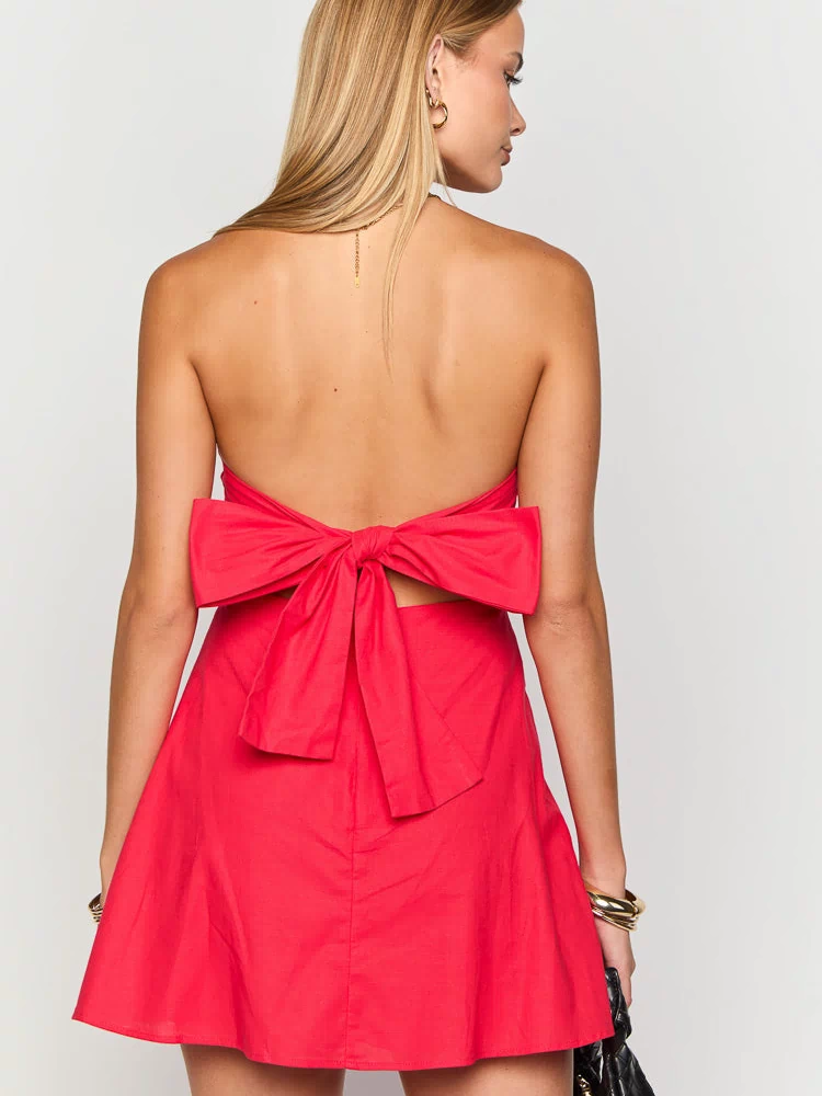 Rear view of a red strapless mini dress with a large bow tie closure and cut-out back