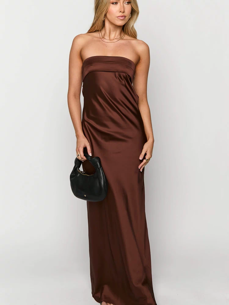 Front view of a brown strapless maxi dress with a smooth satin-like fabric and flowy silhouette