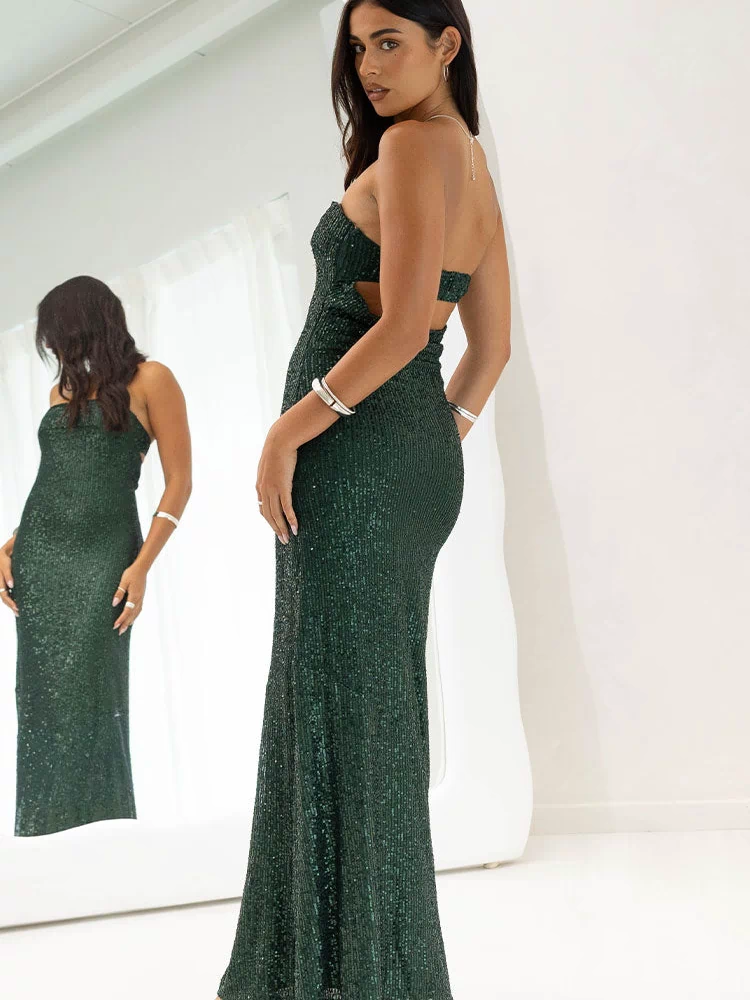 Side view of an emerald green sequin maxi dress with a strapless neckline and side cutout