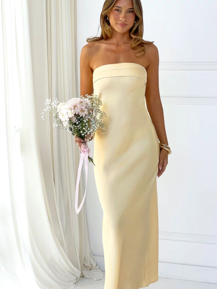 Front view of a yellow strapless maxi dress with a banded neckline and a straight, fitted silhouette